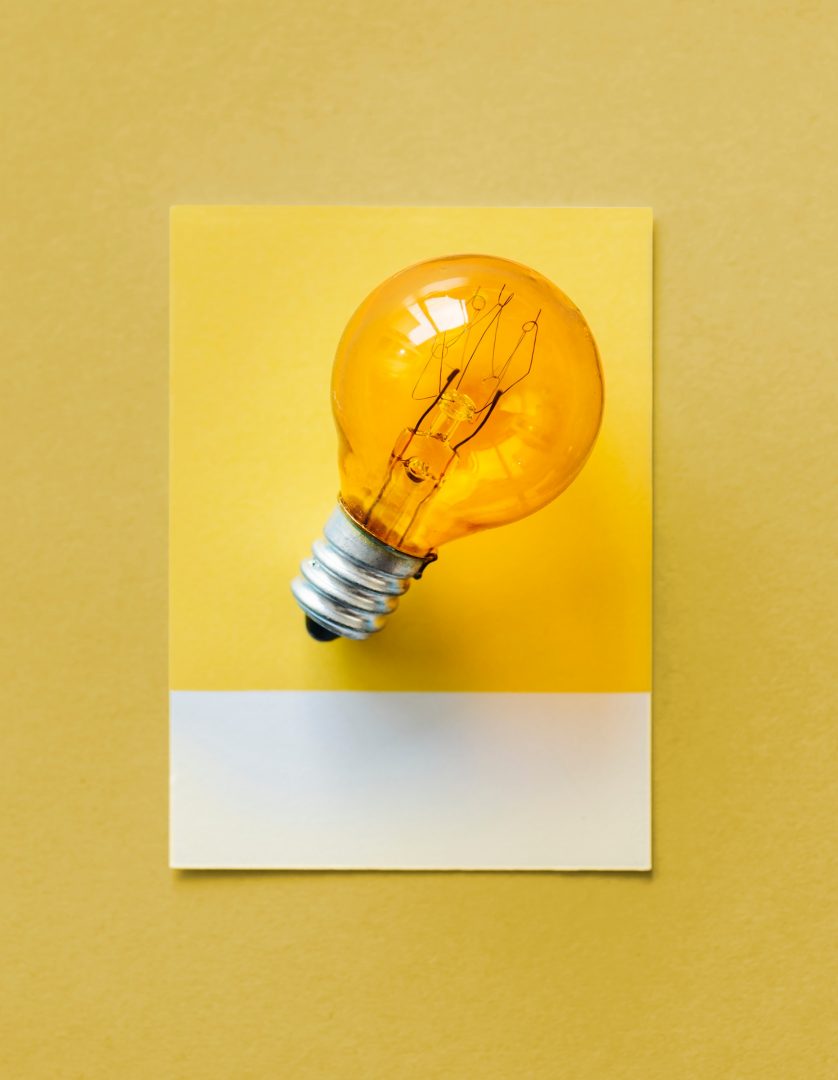 Image of a yellow lightbulb on a yellow background.